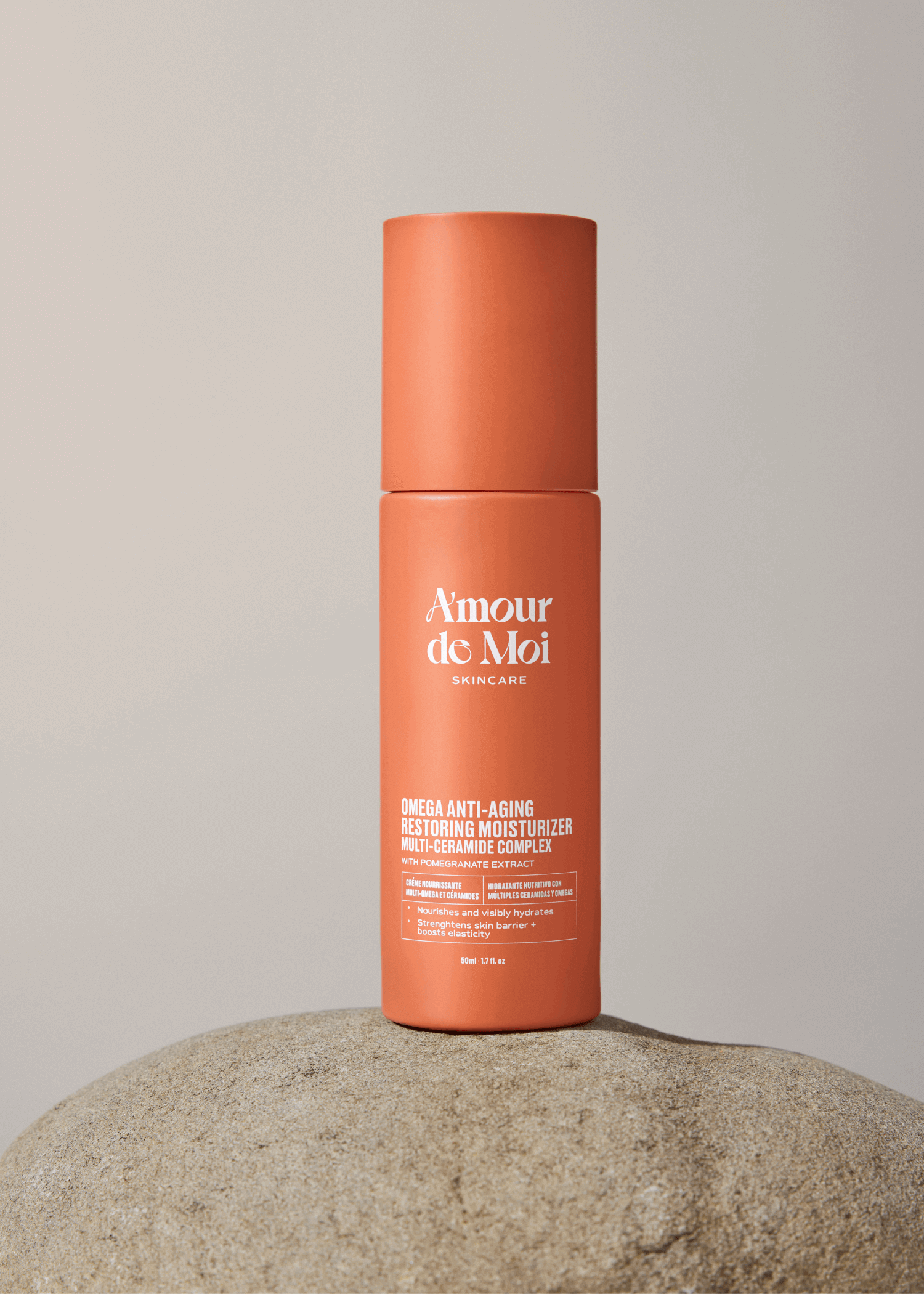 Anti-aging multi ceramide omega skin restoring moisturizer bottle on a stone surface with a neutral background