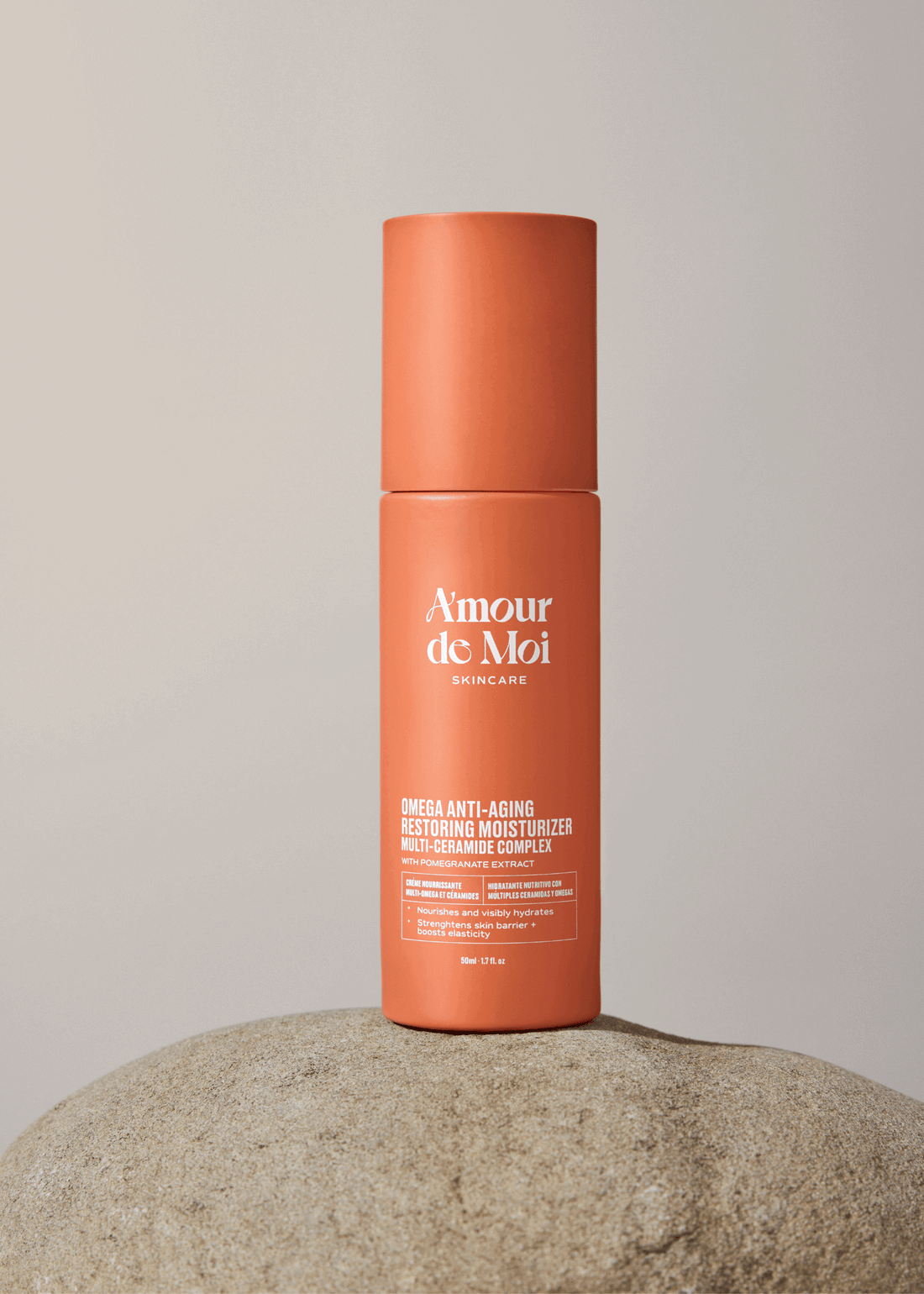 Anti-aging multi ceramide omega skin restoring moisturizer bottle on a stone surface with a neutral background